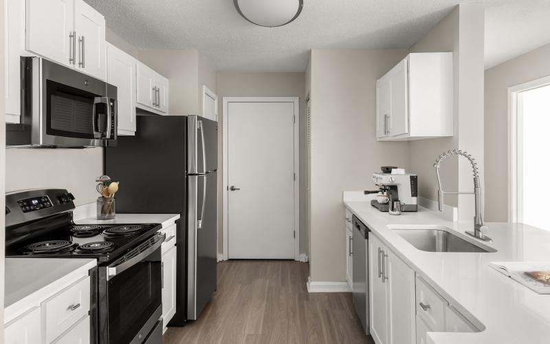 a kitchen with white cabinets