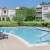 pool area with reclining seats and landscaping